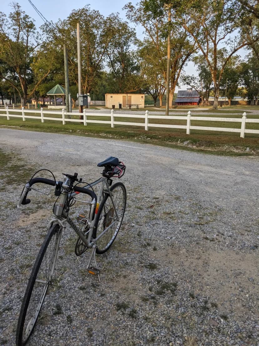 The Peugeot bicycle leaning against a fence at Michael Tucker Park on the Chief Ladiga Trail, early morning, September 2024
