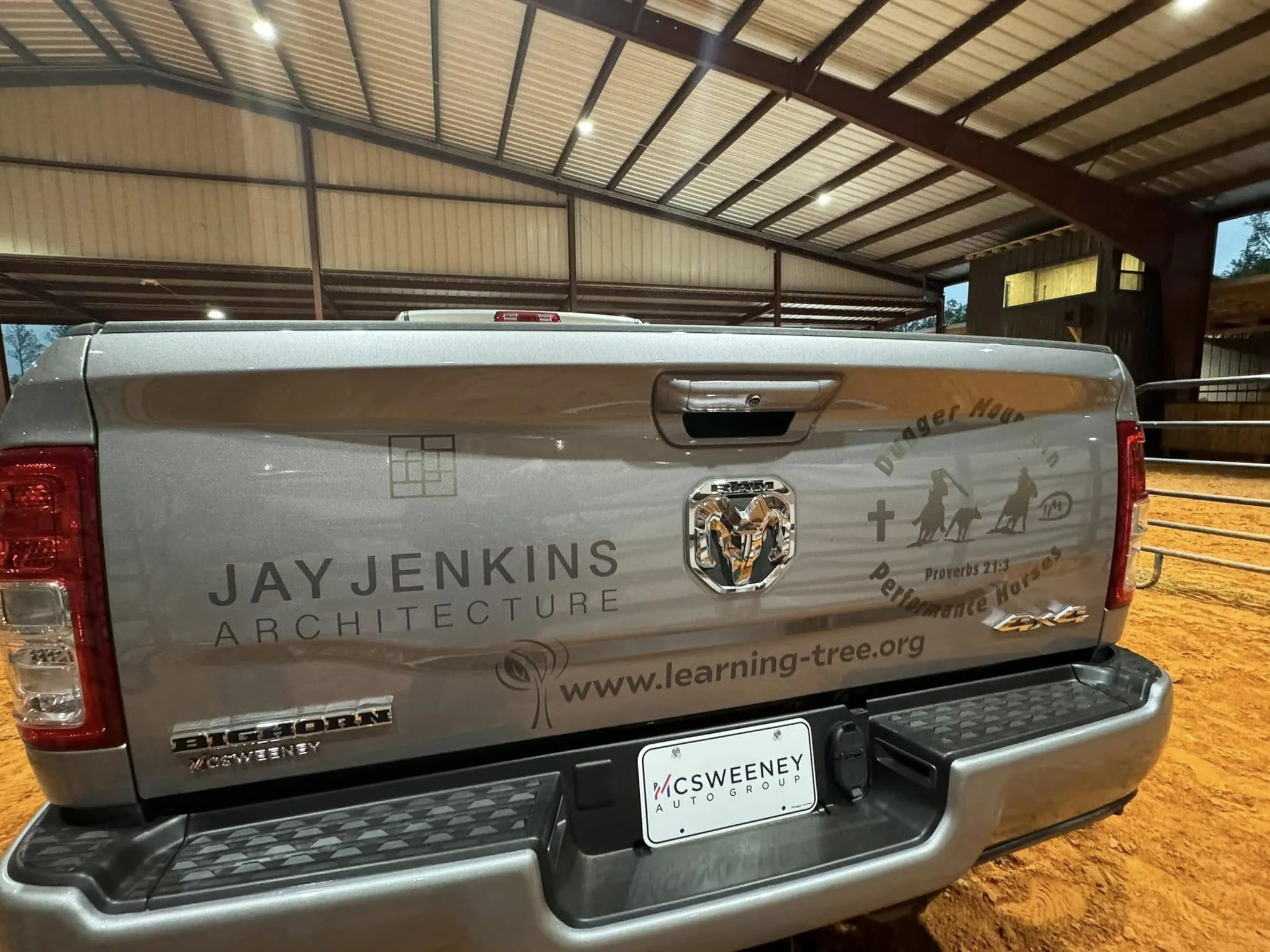 The tailgate of Jay Jenkins's truck wrapped with the Jay Jenkins Architecture logo — the Mondrian grid mark he designed himself