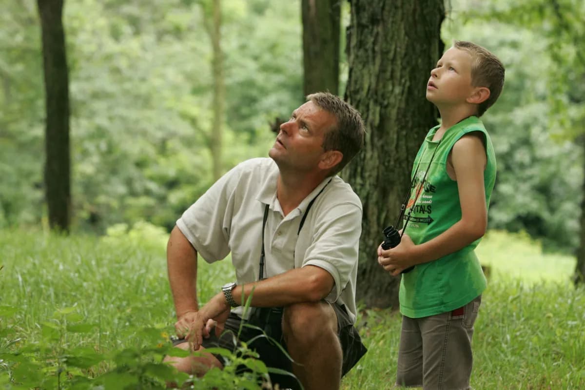 A father and son birdwatching together
