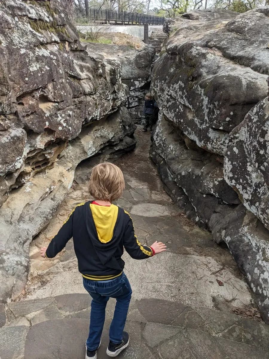 A child explores the rocky gorge trail at Noccalula Falls Park