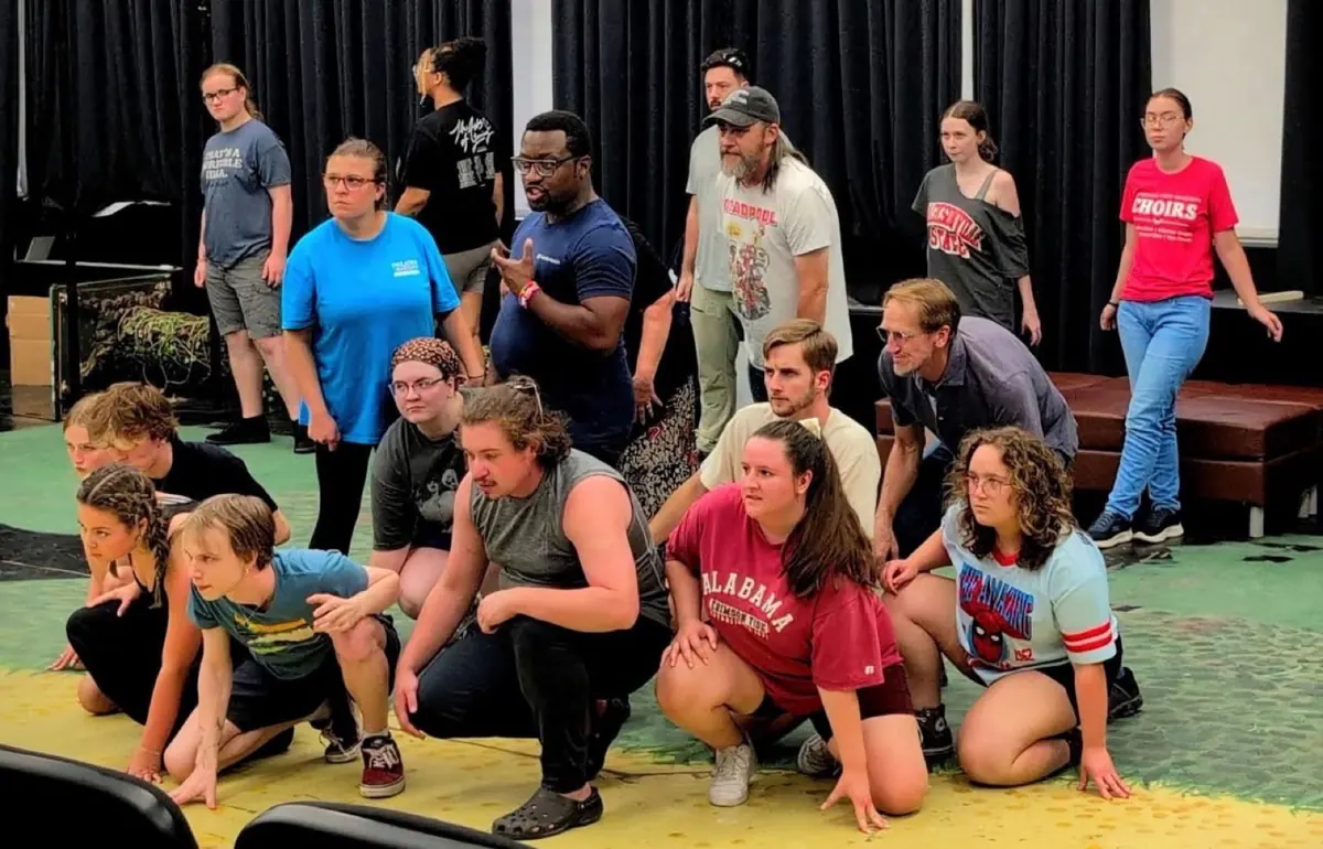 Cast in a circle on the Sweeney Todd stage
