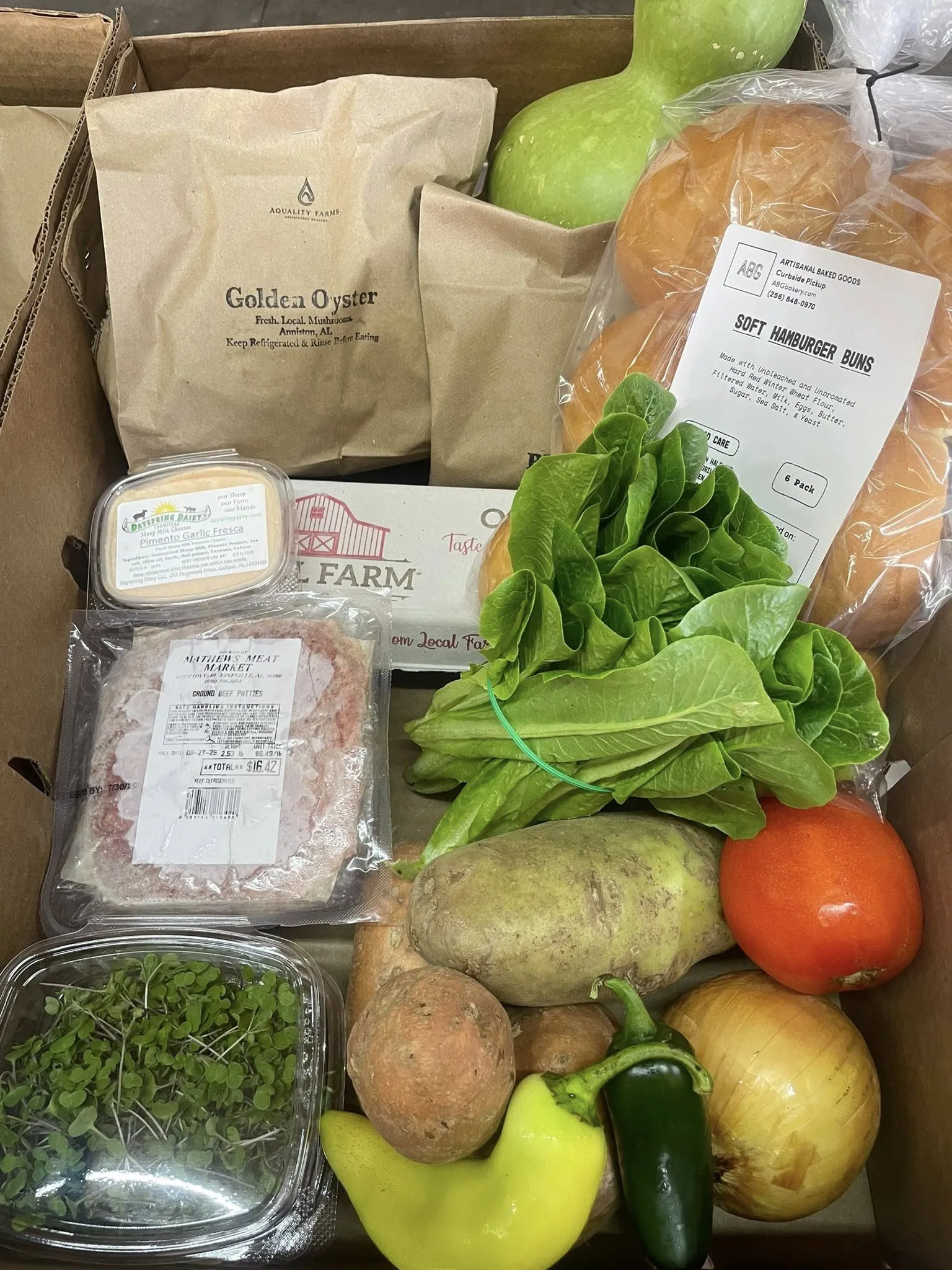Aquality Farms Harvest Box with Golden Oyster mushrooms, butter lettuce, microgreens, sweet potatoes, and other local farm products