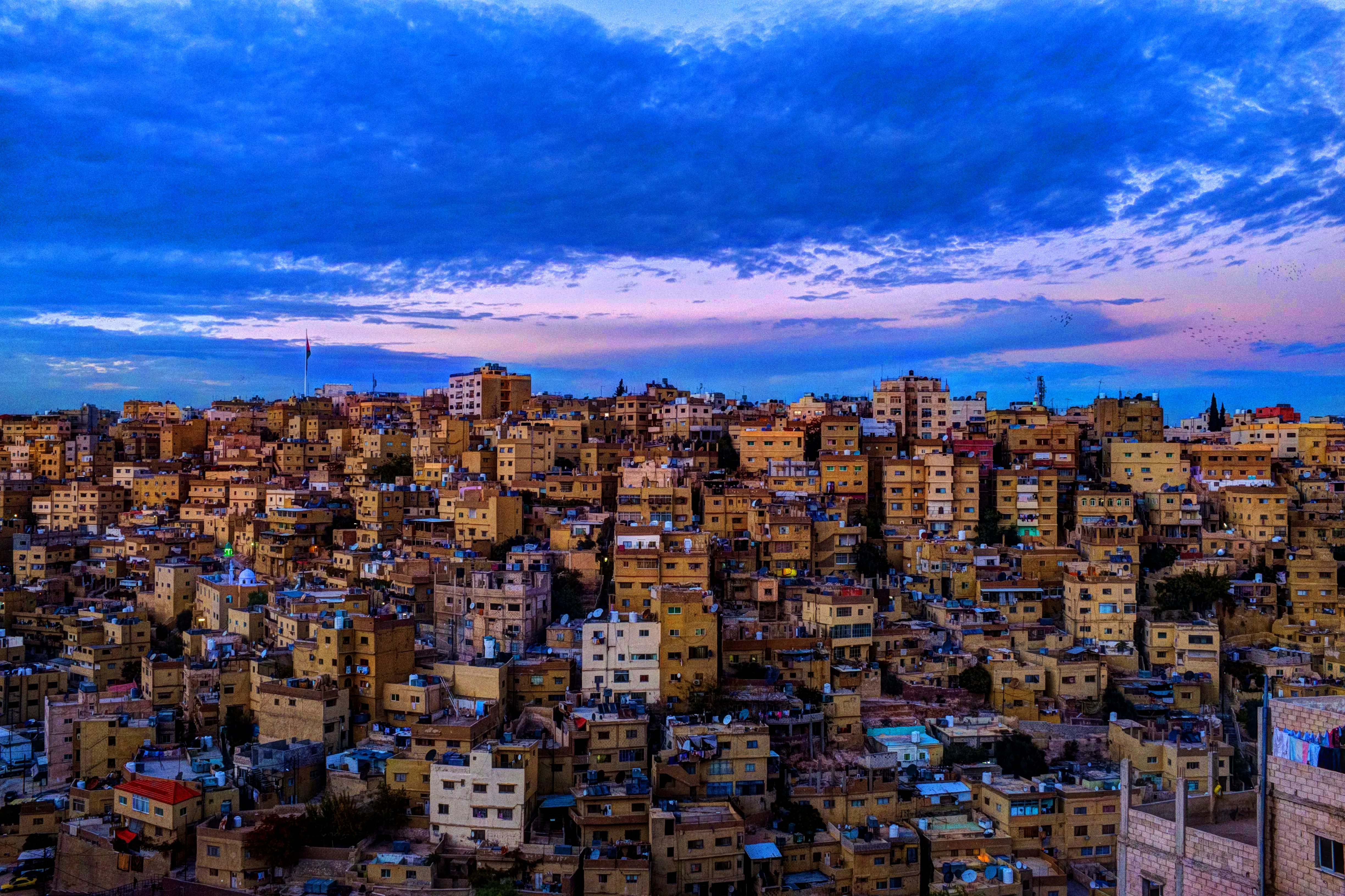 A classical view of Amman, Jordan, white stone houses stacked across the hills of the capital