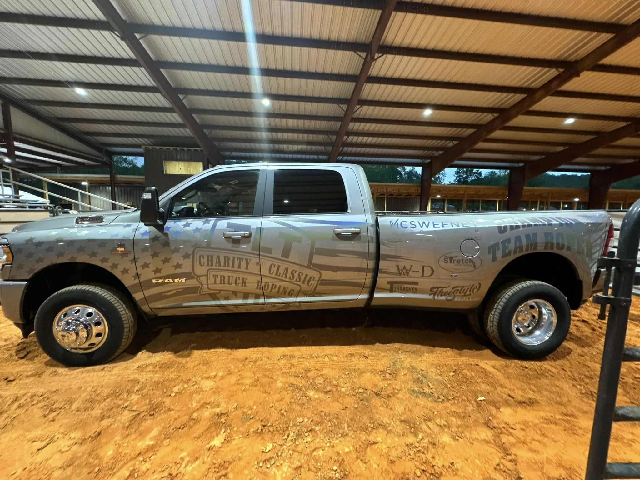 Jay Jenkins's Ram 3500 truck wrapped with Jay Jenkins Architecture branding at a charity roping event